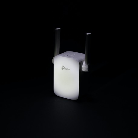 White Wi-Fi booster against a black background