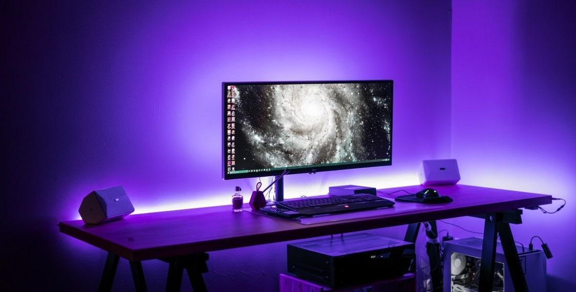 Gaming room setup with purple glowing RGB lights