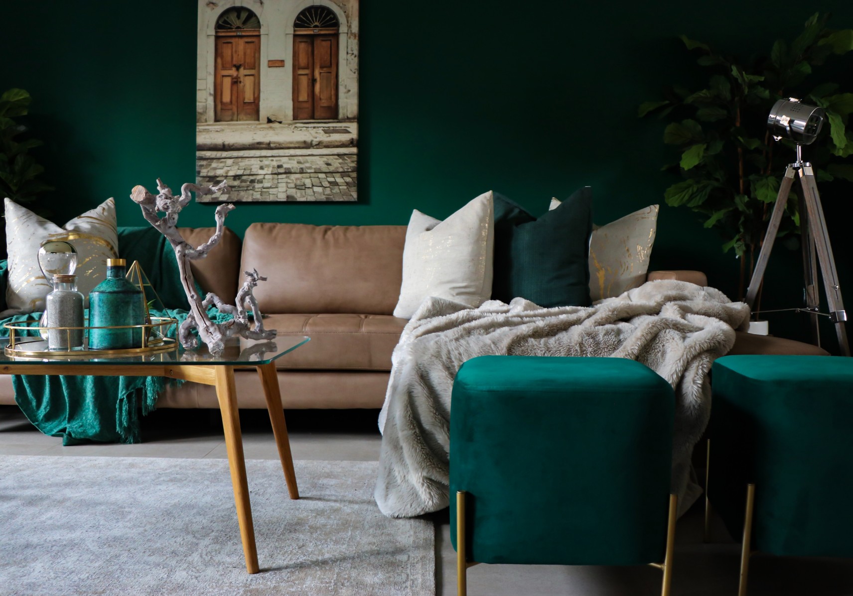 A living room with a deep green colour scheme