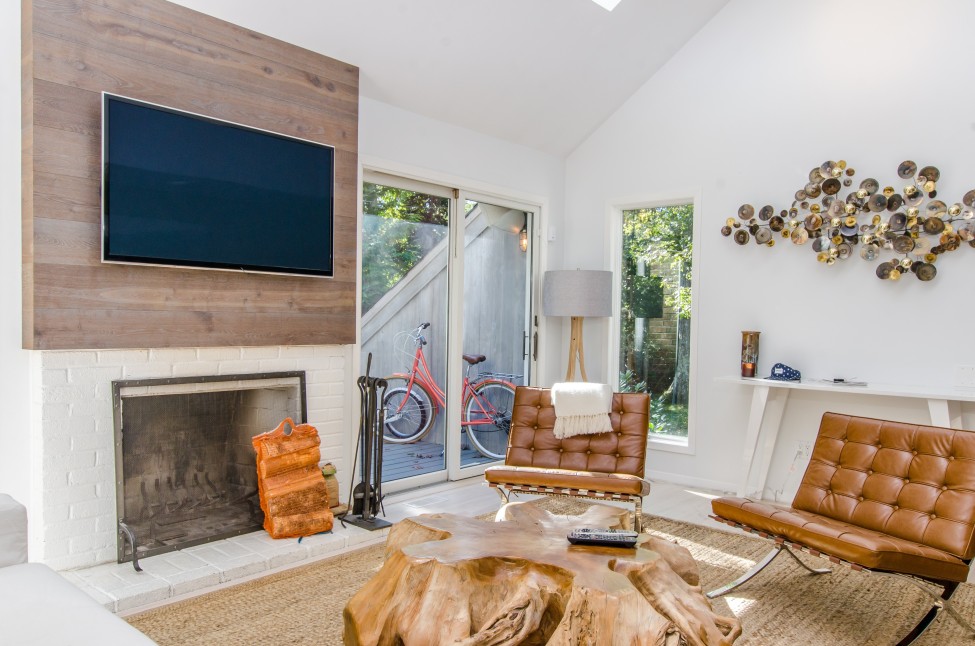 A living room with a wall mounted TV