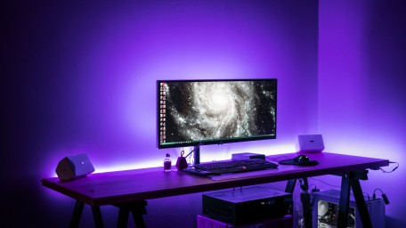 Purple-lit gaming room with computer
