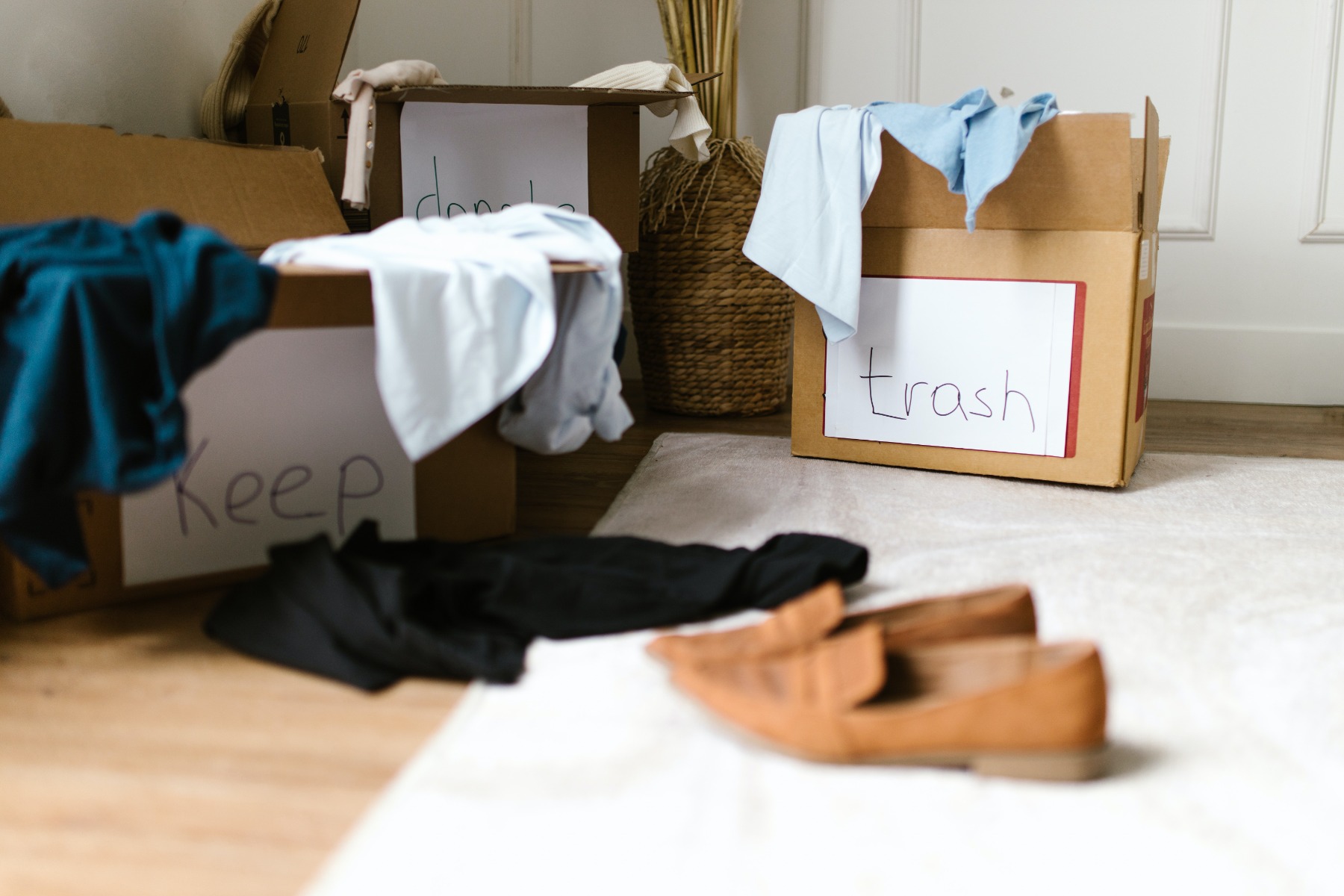 An image of cardboard boxes with clothes and shoes