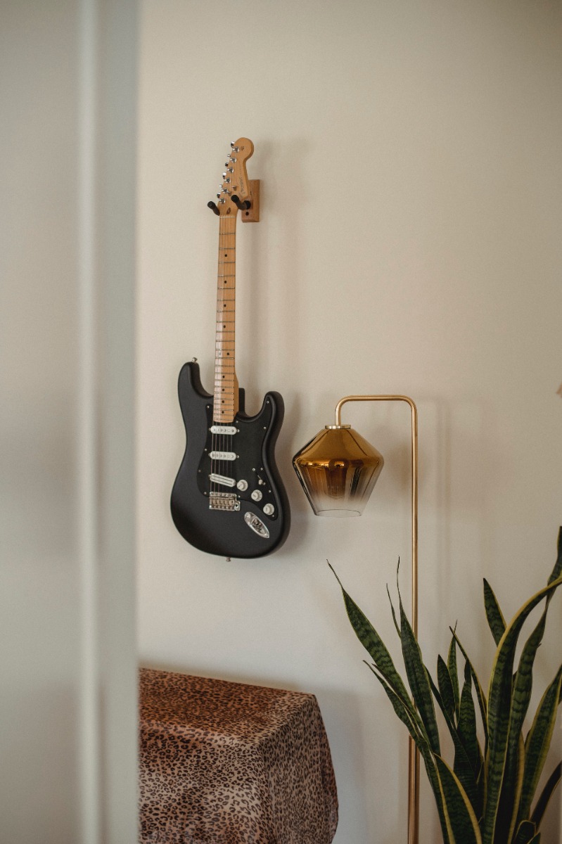 An image of a guitar on the wall