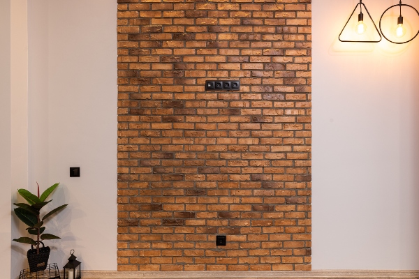 An image of a brick feature wall in a living room
