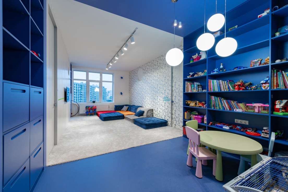 A nursery and playroom with a bright blue colour scheme